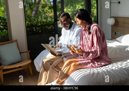 Multicultural couple working remotely, planning finances and investments online. Digital lifestyle Stock Photo