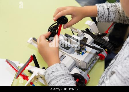 Children are working on model assembly in robotics class. Education Stock Photo