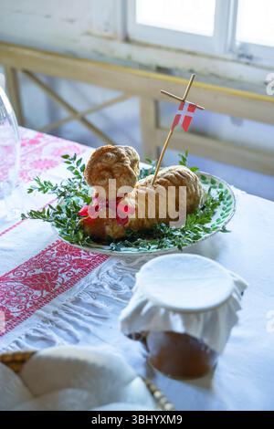 Easter lamb cake with danish flag and boxwood on white tablecloth, celebrating easter traditions in Kourim, Czechia Stock Photo