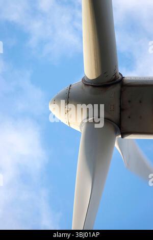 dramatic Low angle detail view of modern wind turbine against a blue sky & scattered clouds, emphasizing renewable energy technology northumberland Stock Photo