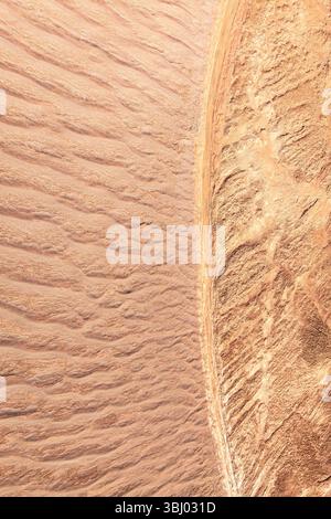 Aerial view capturing the intricate patterns of sand textures in La Puna. The expansive landscape displays the natural formations created by wind over Stock Photo