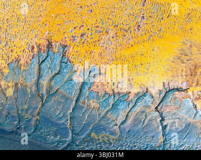 This image showcases an intricate arrangement of abstract fractals in vivid yellow and blue tones. The complex patterns evoke a sense of dynamic motio Stock Photo