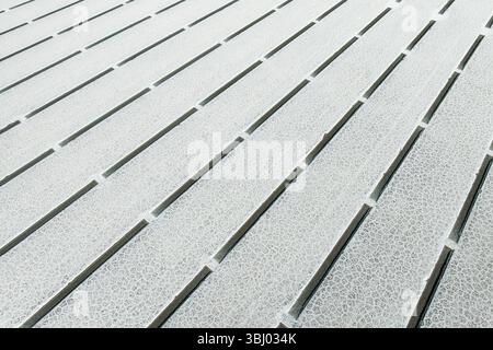 Close-up view of geometric salt formations at Salinas Grandes in Salta, Argentina. The surface displays linear patterns and natural salt crystal textu Stock Photo
