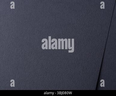 Dark blue matte paper texture with a smooth, striated finish, featuring a subtle, abstract ripple pattern. Elegant and refined design, perfect for mod Stock Photo