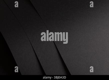 Premium black paper texture with a matte finish. Dark, minimalistic geometric pattern with simple lines overlaying an abstract, elegant backdrop. Expe Stock Photo