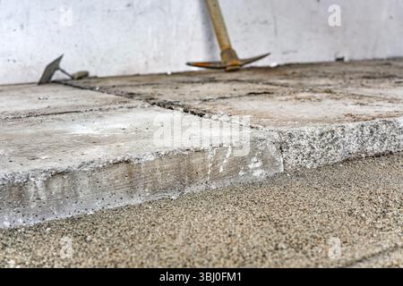 Large old concrete tile blocks on layer of sand - pavement construction, closeup detail Stock Photo