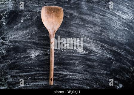 wooden spoon on a black textured table Stock Photo