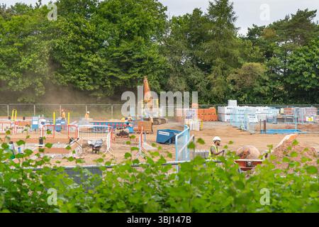 Miller homes residential building site with dusty diggers and ground works on view. Stock Photo