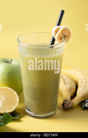 Healthy green smoothie on yellow background Stock Photo