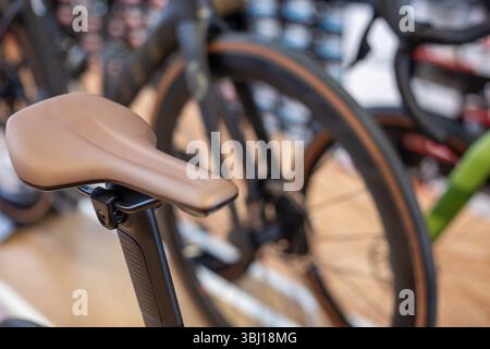 Detail of a sport bicycle saddle. Elegant beige leather seat on a seat post close-up. Stock Photo