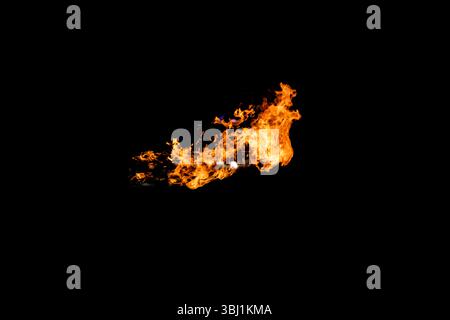 Flames caused by the explosion of the oil isolated on black background. Demonstration of water on oil fire. Stock Photo