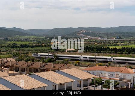 A train passing by Sant Salvador in Catalonia, Spain Stock Photo