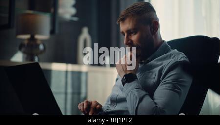 Excited Financial Analyst Working on Laptop, Monitoring Real-Time Stocks, Exchange Market Charts. Successful Businessman Making Profitable Investments, Working in Comfortable Office of Investment Bank Stock Photo