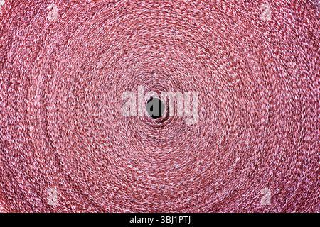 Copper mesh, twisted into a roll, top view. Stock Photo