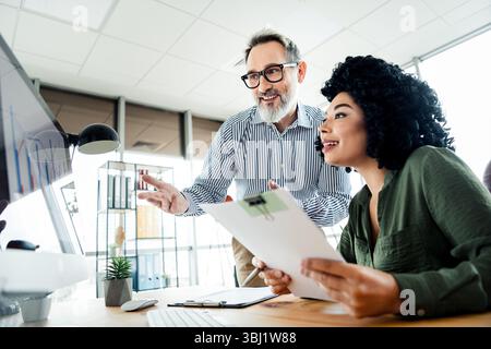 Professional team collaborating on a project in a modern workspace showcasing dynamic interaction and innovative ideas Stock Photo