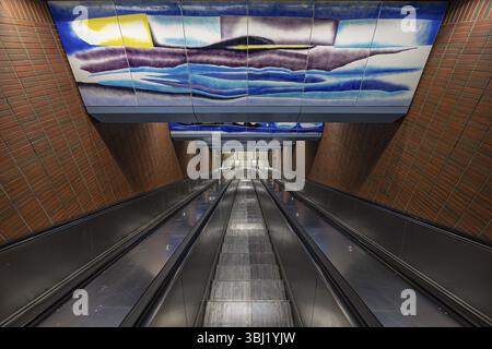 Long escalator in an underground station with colourful ceiling painting, Duisburg, North Rhine-Westphalia, Germany, Europe Stock Photo