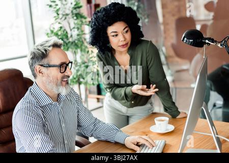 Professional team collaboration in a modern office workspace featuring a diverse and vibrant atmosphere Stock Photo