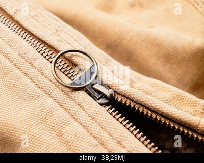 A macro close up photo of a metal zipper on an old coat. Stock Photo