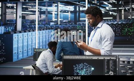 Data center engineer using tablet to interpret AI generated data analytics graphs. Server room worker using artificial intelligence displaying system performance predictive metrics, camera A Stock Photo