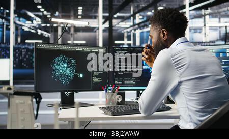 Data center programmer uses neural networks node tree program to identify equipment issues. Server hub employee reviewing AI deep learning data analysis graph to minimize failures, camera A Stock Photo