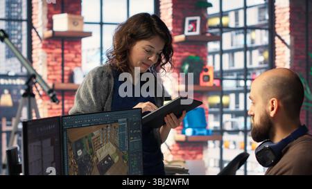 Workers in office use CAD software to design a house interior, providing a user interface for virtual home planning. Team of developers creating architectural layout and adjustments. Camera B. Stock Photo