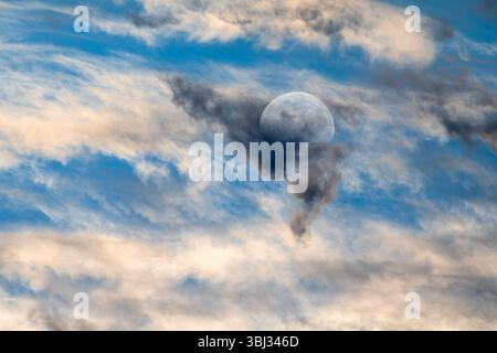 The Colorful Ethereal Moon Against A Detailed Colorful Cloudscape Stock Photo