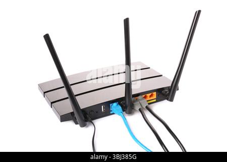 Modern wi-fi router with cables on white background Stock Photo