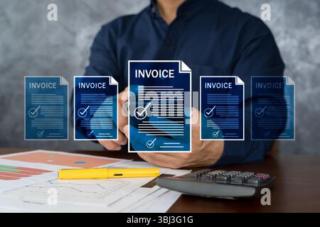 A businessman processes multiple digital invoices using a smartphone with financial documents, charts, pen, and calculator on the table. Concept of on Stock Photo