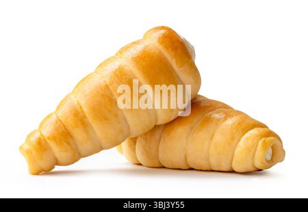 Side view of two puff pastry cream horns in stack is isolated on white background with clipping path. Stock Photo