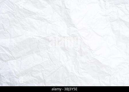 Top view and full frame of wrinkled or crumpled white paper texture is used as crumpled white paper background texture in decorative art work. Stock Photo