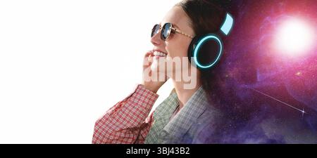 Young woman listening to music with headphones on white background, double exposure with universe Stock Photo