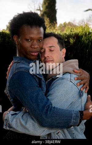 Two men hugging each other in a park, showing love and affection Stock ...