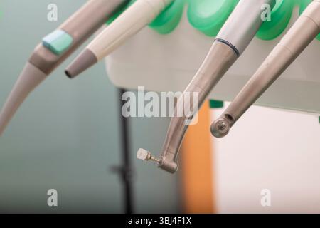 Close up view of modern dental tools hanging in a well equipped dental clinic, prepared for the upcoming patient visit Stock Photo