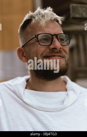 Man smiling in white hoodie Stock Photo