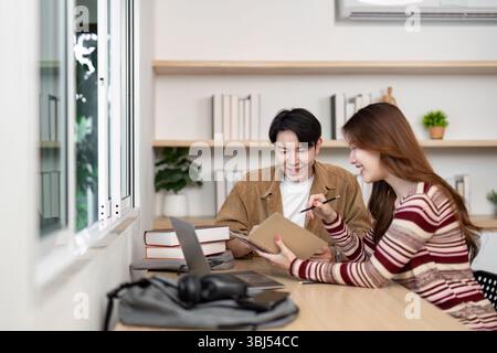 Collaborative Learning Environment. Two students discussing project ideas in modern workspace. Stock Photo