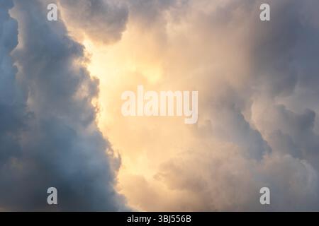 Sun lights is shining between storm clouds Stock Photo