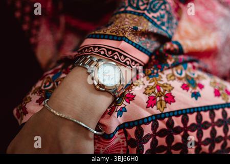 Bracelet and gold jewelry watch on a woman's hand, elegant details and accessories Stock Photo