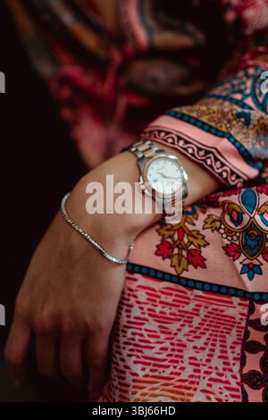 Bracelet and gold jewelry watch on a woman's hand, elegant details and accessories Stock Photo