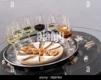 SPANISH WINE tasting glasses alfresco situation red and white wine selection, cheese & biscuits on barrel end with corks Lanzarote Canary Islands Stock Photo