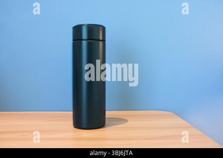 Thermos on the table on an empty background. High quality photo Stock Photo