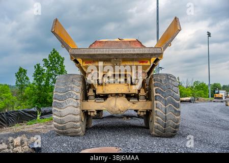 Back of an empty large industrial dump truck on a construction site. Stock Photo
