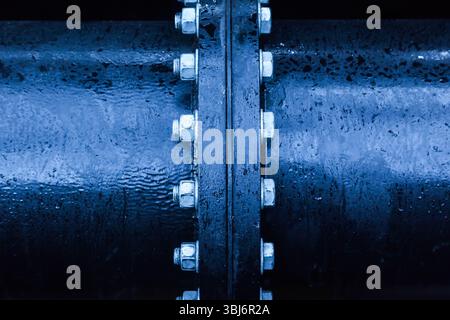 Large pipe connection with a large number of bolts and nuts enclosed on it. Pipeline. Pipeline state transportation system. Stock Photo