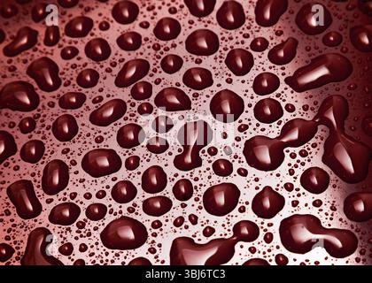 Water droplets on a red surface with light and shadow on the surface. Stock Photo