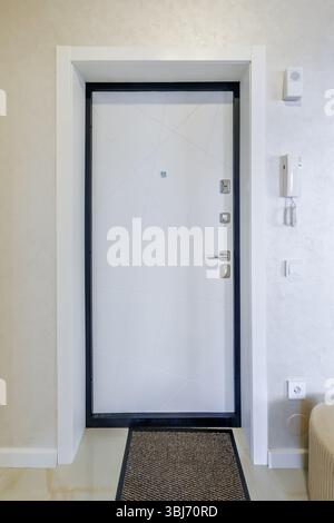modern door handle on white wooden door in interior. Knob close-up elements. Door handle, fittings for interior design Stock Photo