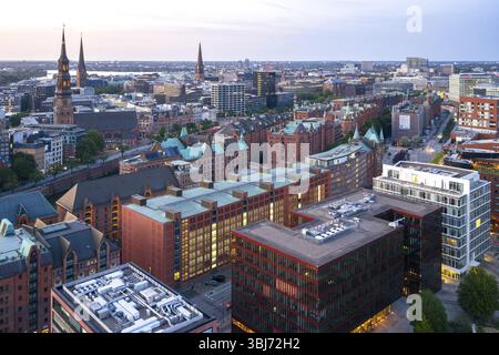 Aerial view of the Speicherstadt with striking brick buildings and high towers under an evening sky, Hamburg, Germany, Europe Stock Photo