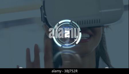 Smiling woman wearing white VR headset using holographic countdown HUD at tech demo, hand gesture Stock Photo