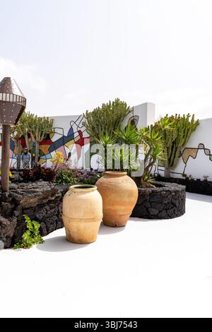 View of a garden with large pottery, and a colorful mural from the Cesar Manrique Foundation in Lanzarote. Stock Photo
