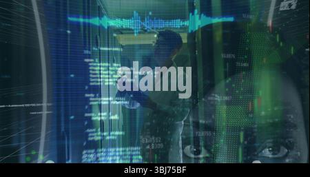 Analyzing data engineer holding tablet in data center, with server racks and holographic overlays Stock Photo