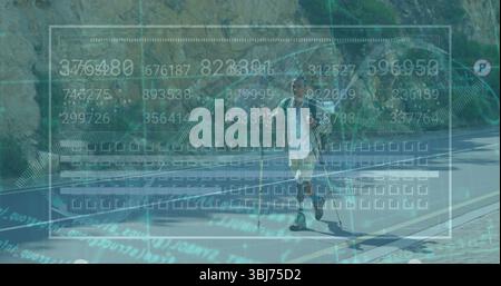 Walking mid adult hiker using two trekking poles along winding mountain road, with digital overlay Stock Photo