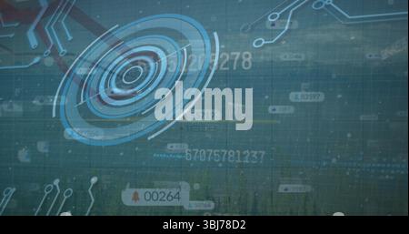 Displaying holographic circular interface overlaying forest showing data streams and circuit lines Stock Photo